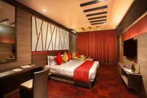 a hotel room with a bed and a television at Germanus Springs Kodaikanal in Kodaikānāl +53 photos