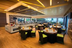 a restaurant with tables and chairs and a bar at Germanus Springs Kodaikanal in Kodaikānāl