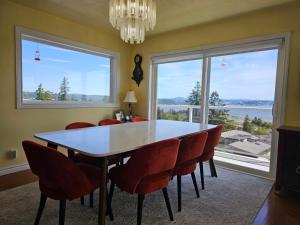 a dining room with a table and chairs and a large window at HOV B&B House -Hospitality Ocean View Victoria- in Victoria