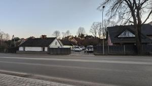 a house on the side of a street with houses at Baltā māja 56m2 in Tukums