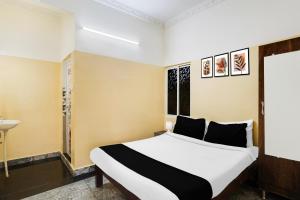 Postel nebo postele na pokoji v ubytování Super Hotel O Karakambadi Road Near Leela Mahal Circle