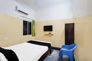 Postel nebo postele na pokoji v ubytování Super Hotel O Karakambadi Road Near Leela Mahal Circle