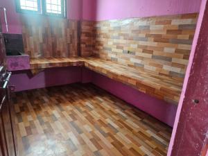 a bathroom with a wooden bench in a room at Cicily Cottage in Munnar