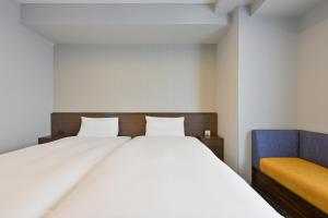 Postel nebo postele na pokoji v ubytování Via Inn Okayama
