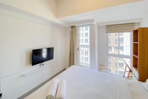 Μια τηλεόραση ή/και κέντρο ψυχαγωγίας στο Chic and Cozy Studio at Tokyo Riverside PIK 2 Apartment By Travelio