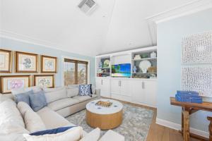 a living room with a white couch and a coffee table at Anchored Here home in Captiva