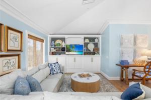 a living room with a couch and a table at Anchored Here home in Captiva