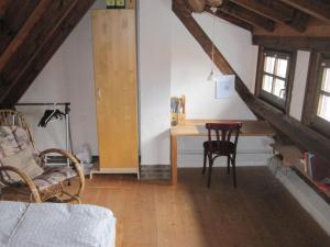 a living room with a table and a chair at Ferienhaus Fam. Fuhrer in Hohenaltheim