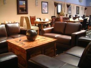 a waiting room with leather couches and a table at Skegness The Royal Hotel in Skegness