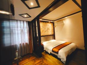 Krevet ili kreveti u jedinici u objektu 张家界如晤山居人文客栈