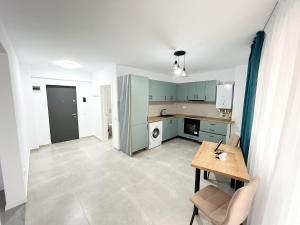 a kitchen with green cabinets and a table in a room at ONE Apartment in Iaşi