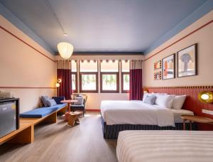 a hotel room with two beds and a flat screen tv at Blu Dock Restel Bangkok in Bangkok