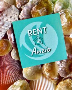 a sign sitting on top of a pile of pastries at DOMUS MARI a due passi dal mare Anzio Cincinnato in Anzio