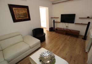 a living room with a couch and a flat screen tv at Apartment Milica in Petrovac na Moru
