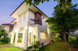 a white house with a tree in front of it at Near airport cozy home in Chiang Mai
