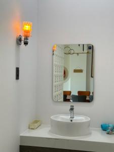 a bathroom with a sink and a mirror at Hue An Villa in Bình Tú +22 photos