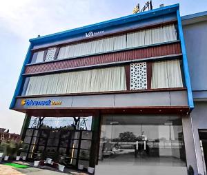 a building with a sign on the front of it at BlueNeck Ayodhya-Near ShriRam Mandir in Ayodhya