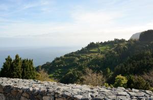 a view of the ocean from a rock wall at Aldeia do Priolo in Nordeste