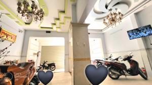 a group of motorcycles parked in a room with hearts at Thuỳ Trang Hotel in Ho Chi Minh City +16 photos