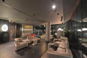 a room with couches and chairs in a building at Best Western Plus Net Tower Hotel Padova in Padova