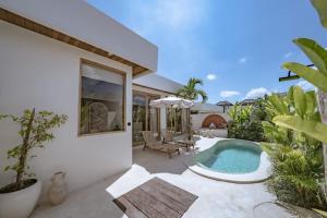 a house with a swimming pool in a yard at Villa Samara Pererenan in Tumbak Bayuh +29 photos