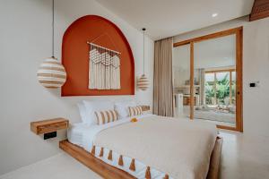 a bedroom with a white bed and a large window at Villa Samara Pererenan in Tumbak Bayuh