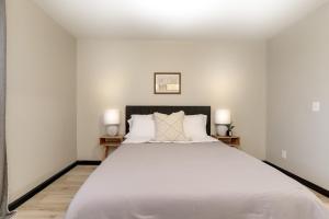 a bedroom with a large white bed with two night stands at Amazing East Side 3BR 2BA Wifi Smart TV in Wichita +11 photos
