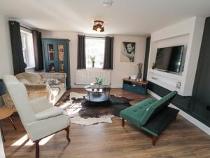 a living room with a couch and a table at The Ducklings Nest in Middlesbrough