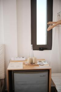 a table with a vase on top of a tv at Dori Homestay in Hue +83 photos