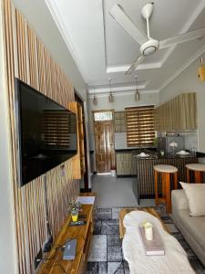 a living room with a couch and a tv at Goba's Hidden Gem Local Charm in Dar es Salaam