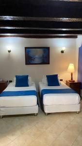 Voodi või voodid majutusasutuse Hotel Don Pedro De Heredia toas