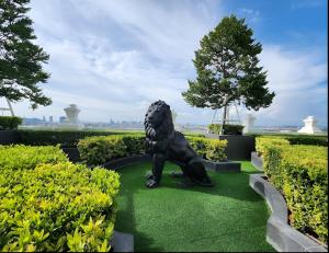 eine Statue eines Löwen im Garten in der Unterkunft The Empire Tower Pattaya in Jomtien Beach