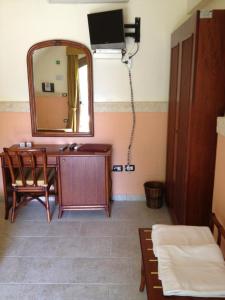 a bathroom with a mirror and a desk with a mirror at Relais Reggia Domizia in Manduria