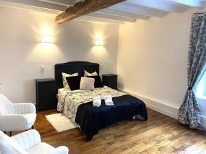 ein Schlafzimmer mit einem Bett mit zwei Schuhen drauf in der Unterkunft Une histoire de famille in Écordal