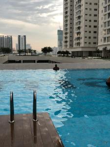 a man in a swimming pool in a city at Maxim Citylight in Kuala Lumpur