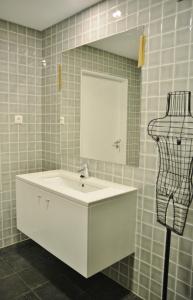 a bathroom with a white sink and a mirror at Aldeia do Priolo in Nordeste