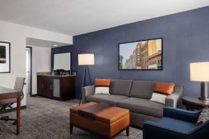 a living room with a couch and a table at Embassy Suites Birmingham in Birmingham