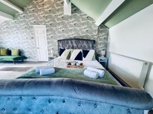 a bedroom with a large bed with two pillows at The Georgian Manor House in Whitehaven