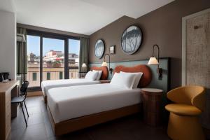 罗马The Spring House Hotel Rome Vatican, Tapestry Collection Hilton的有两张床和一扇窗户的酒店房间