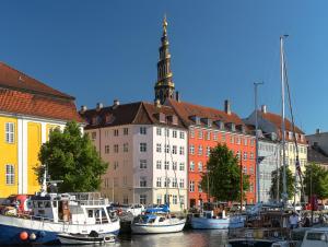a group of boats docked in front of a building at CanalLiving-CPH in Copenhagen
