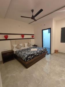 a bedroom with a bed and a ceiling fan at Hotel Crown Plaza in Jalandhar