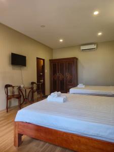 Postel nebo postele na pokoji v ubytování BUNGALOW HOTEL