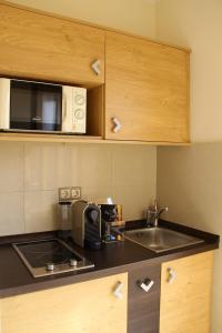 A kitchen or kitchenette at Sétány Apartman