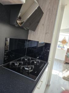 a black stove top oven in a kitchen at Langewieke in Hollum +8 photos