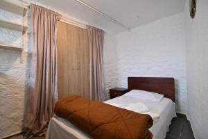 a small bedroom with a bed and a window at Stelios Home in Nea Vrasna