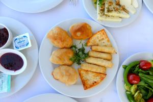 a white plate of food on a table at Bay Nihat Otel Lale in Ayvalık