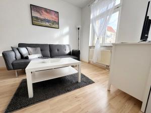 a living room with a couch and a coffee table at Fully equipped Apartment with Balcony in Zwickau