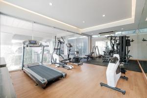 a gym with several treadmills and elliptical machines at Boss Hotel in Bangkok +193 photos