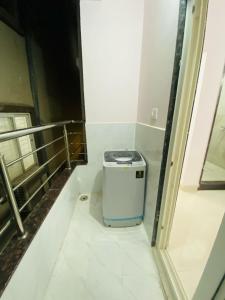 a bathroom with a trash can in a room at Freedom Flats-Extended stay in Kondapur