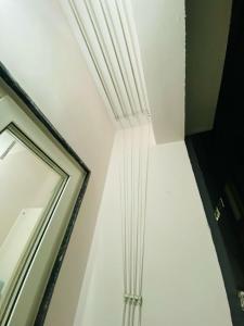 a room with white ceilings and a mirror at Freedom Flats-Extended stay in Kondapur +1 photo